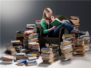Girl reading stacks of books 